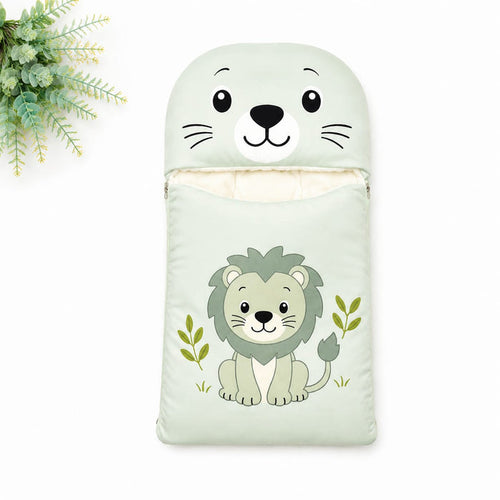 A baby sleeping bag or pouch in pale mint green, featuring a cartoon lion illustration on the front and a matching lion face hood. The pouch is shown on a white background with a decorative green plant in the top-left corner.
