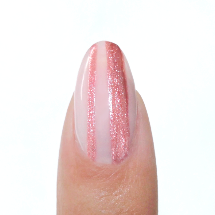 Venus Pink liner used for a metallic pink vertical stripe on a sheer nude nail