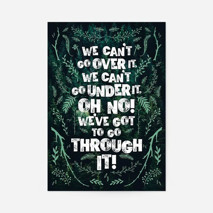Green typography print with "We Can't Go Over It" quote, framed by dark green forest foliage.
