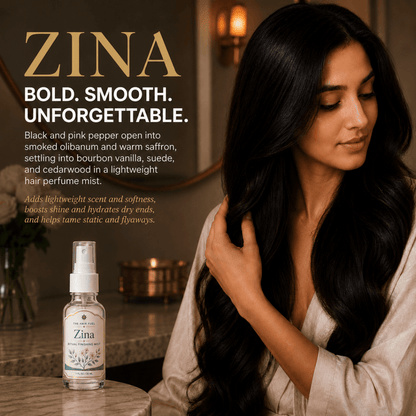Woman with long hair holding a bottle of Zina hair product in a warm indoor setting.
